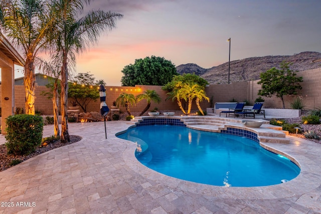 4618 W Pokeberry Ln, Phoenix, AZ 85083 - pool at dusk featuring a patio, a fenced backyard, and a mountain view