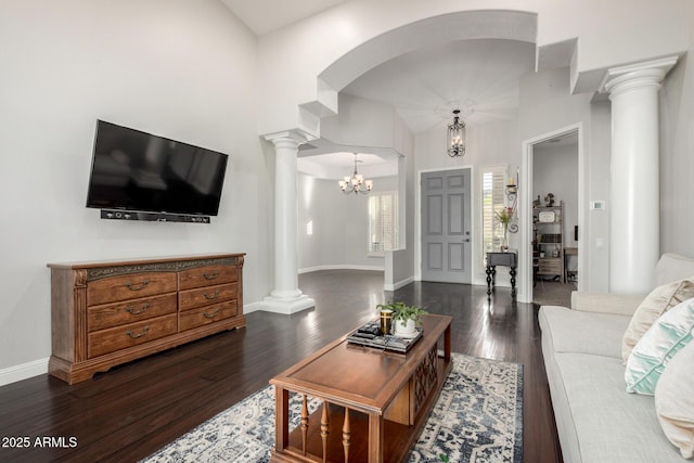 4618 W Pokeberry Ln, Phoenix, AZ 85083 - living room with ornate columns, dark wood-type flooring, a chandelier, and arched walkways