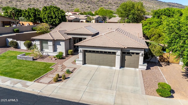 4618 W Pokeberry Ln, Phoenix, AZ 85083 - ranch-style home featuring a tile roof, an attached garage, concrete driveway, stucco siding, and a mountain view