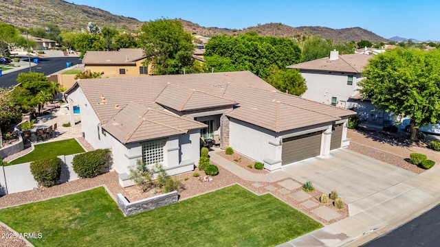 4618 W Pokeberry Ln, Phoenix, AZ 85083 - view of front of house featuring driveway, a garage, stucco siding, and a mountain view