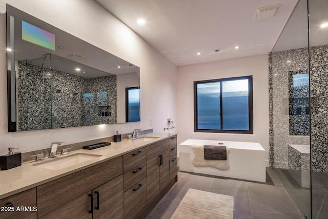 full bath with double vanity, a shower stall, a freestanding bath, and a sink