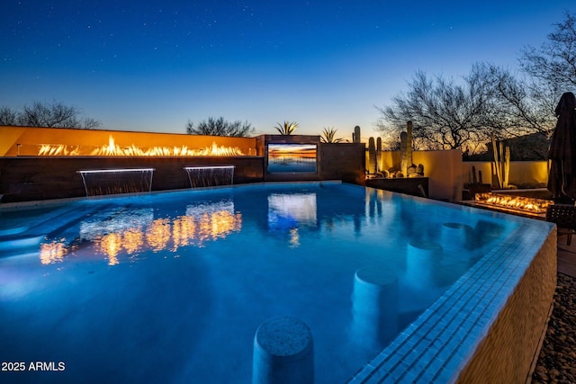 pool at dusk with a fenced in pool and fence