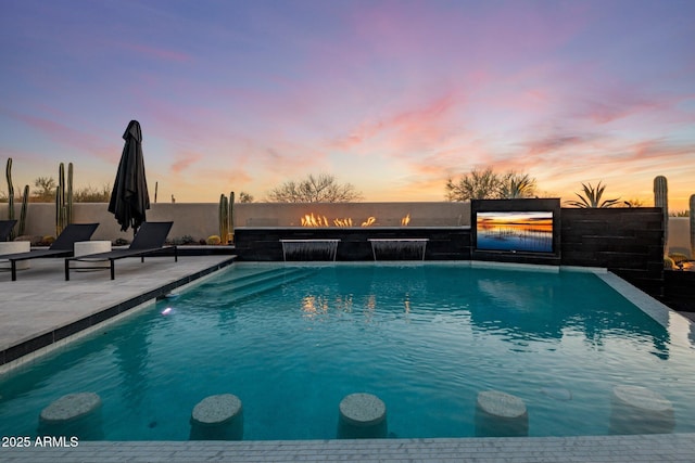 view of pool featuring a patio, a fenced in pool, and fence