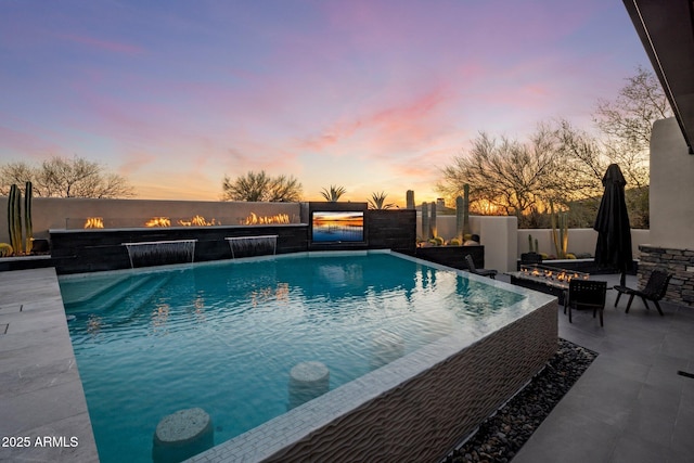 view of pool featuring a patio area, a fire pit, a fenced in pool, and fence private yard