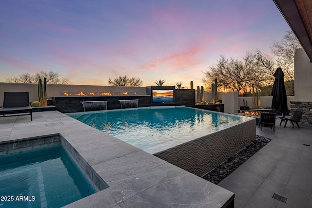 pool at dusk with a fenced in pool, a fire pit, a patio, and fence