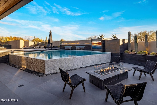 view of swimming pool with fence, a patio area, a fenced in pool, and an outdoor fire pit