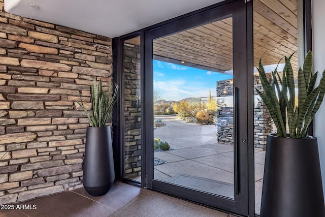 doorway with floor to ceiling windows and a mountain view