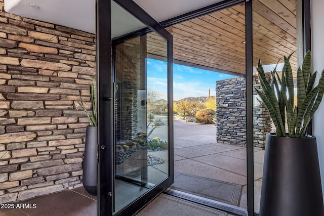 doorway featuring a mountain view and a wall of windows