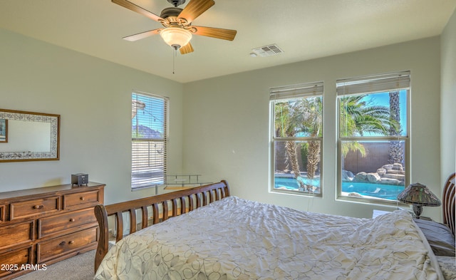 carpeted bedroom with ceiling fan and visible vents