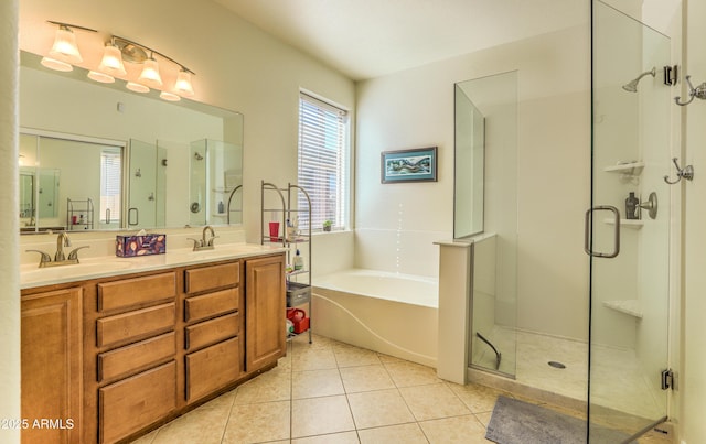 full bathroom featuring a garden tub, a stall shower, a sink, and tile patterned floors