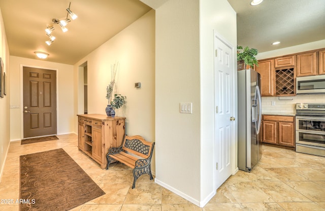 foyer with recessed lighting and baseboards