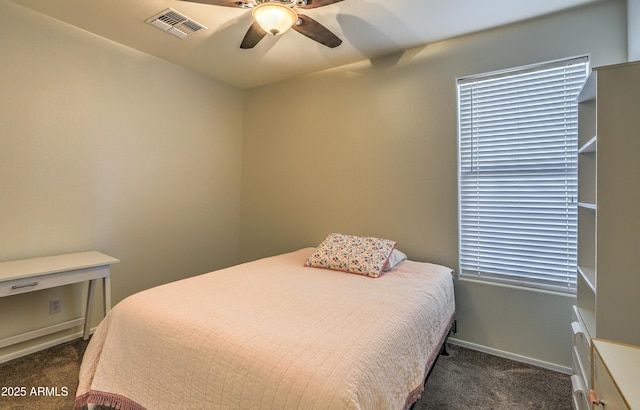 carpeted bedroom with a ceiling fan, visible vents, and baseboards