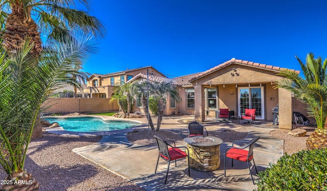 view of pool with a patio, an outdoor fire pit, fence, and a fenced in pool