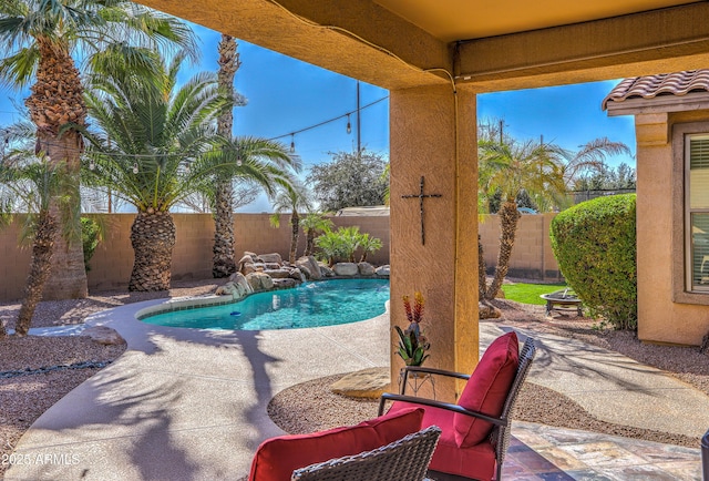 view of swimming pool with a fenced in pool, a fenced backyard, and a patio