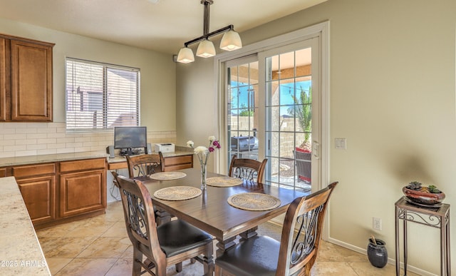 dining area featuring baseboards and light tile patterned floors