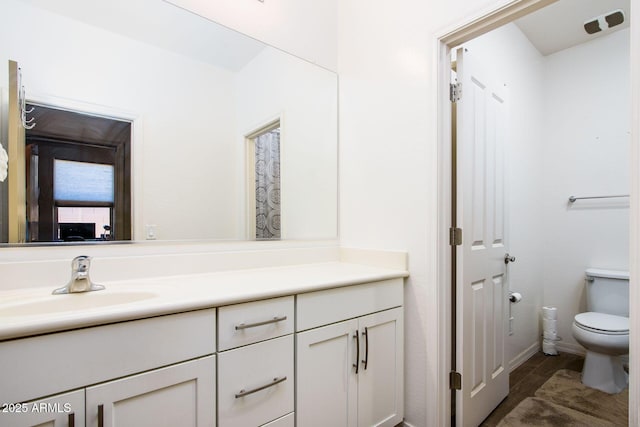 bathroom featuring vanity and toilet