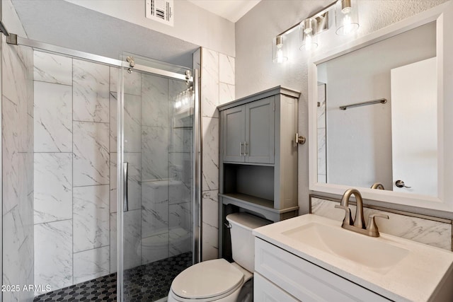 6743 S Jentilly Ln, Tempe, AZ 85283 - bathroom featuring toilet, visible vents, a marble finish shower, and vanity