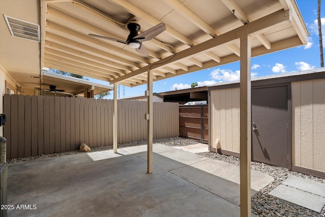 6743 S Jentilly Ln, Tempe, AZ 85283 - view of patio / terrace featuring an outdoor structure, fence, a shed, a ceiling fan, and visible vents