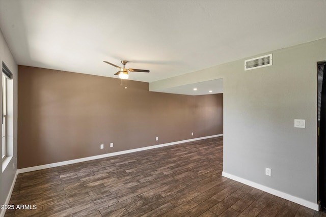 6743 S Jentilly Ln, Tempe, AZ 85283 - empty room with visible vents, a ceiling fan, baseboards, and dark wood-style floors