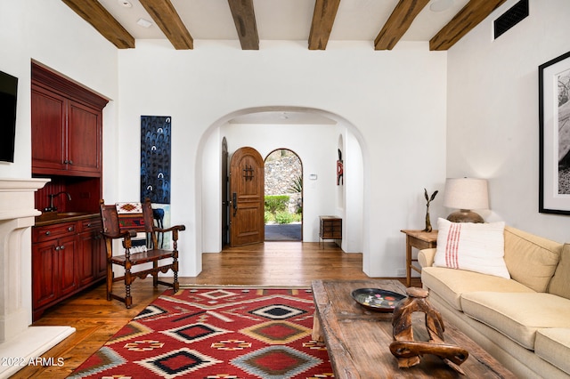 living room featuring dark hardwood / wood-style flooring and beam ceiling