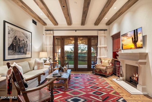 living room featuring french doors, beamed ceiling, and light hardwood / wood-style flooring