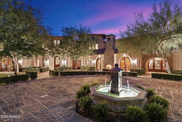 mediterranean / spanish-style house featuring french doors