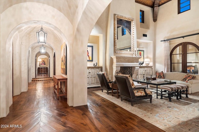 interior space with a towering ceiling and dark hardwood / wood-style floors