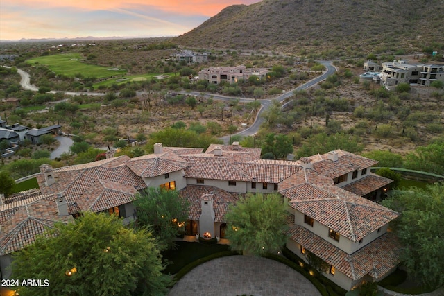 aerial view at dusk featuring a mountain view