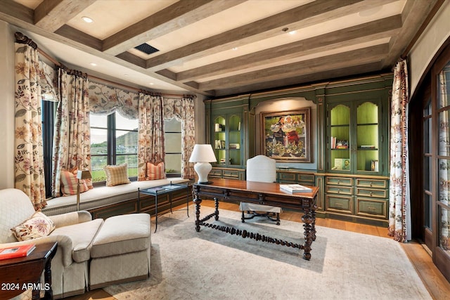 office featuring light wood-type flooring, coffered ceiling, and beam ceiling