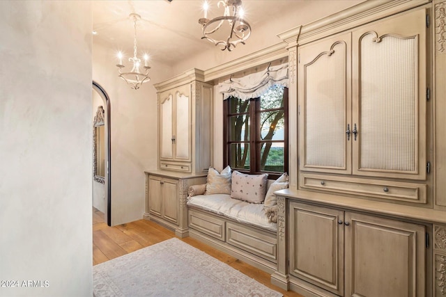 mudroom featuring a notable chandelier and light wood-type flooring