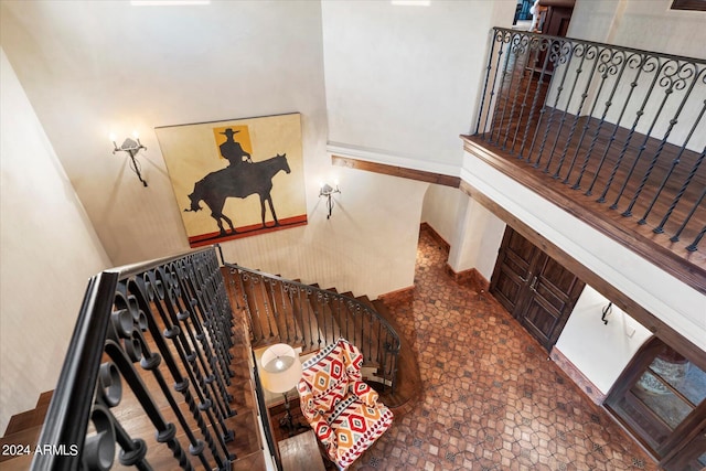 stairs featuring a towering ceiling