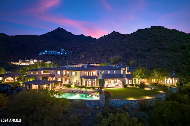 back house at dusk featuring a mountain view