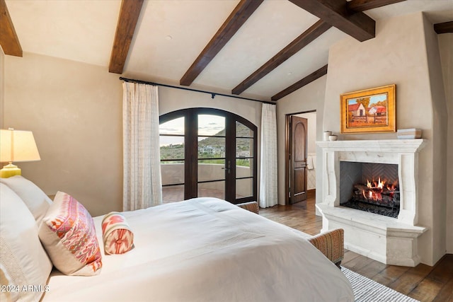 bedroom featuring a fireplace, wood-type flooring, french doors, access to exterior, and lofted ceiling with beams