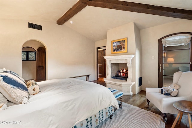 bedroom with wood-type flooring and lofted ceiling with beams