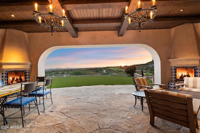 patio terrace at dusk with an outdoor living space with a fireplace