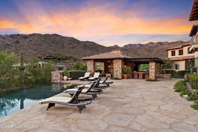 patio terrace at dusk with a mountain view