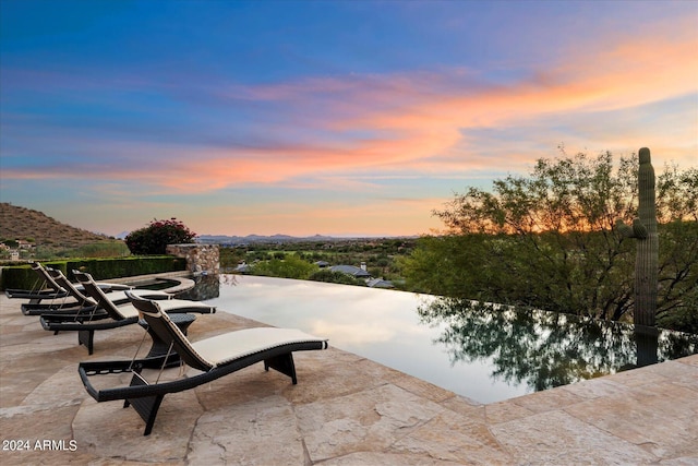 view of pool at dusk