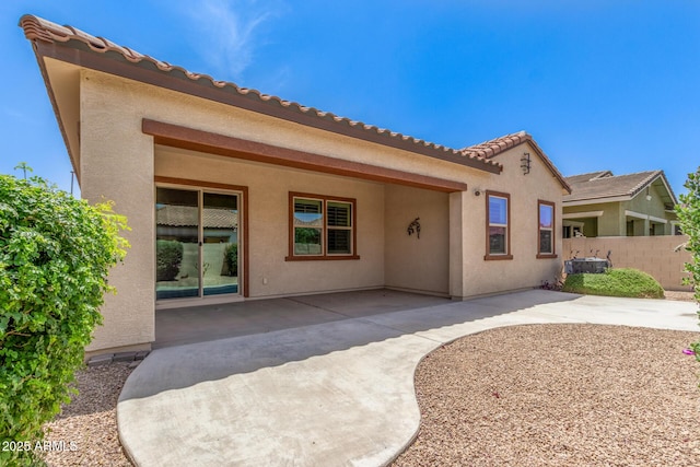 back of property featuring a patio, fence, and stucco siding