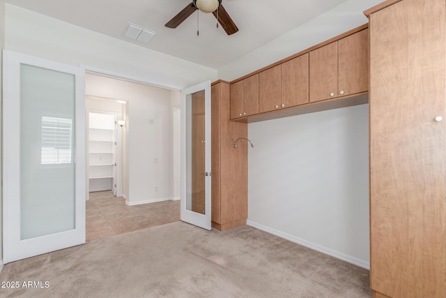 unfurnished bedroom with light colored carpet, french doors, ceiling fan, and baseboards