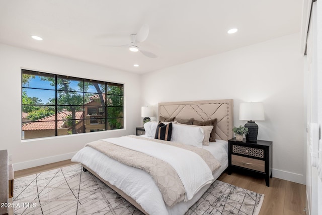 bedroom with recessed lighting, baseboards, and light wood-style floors