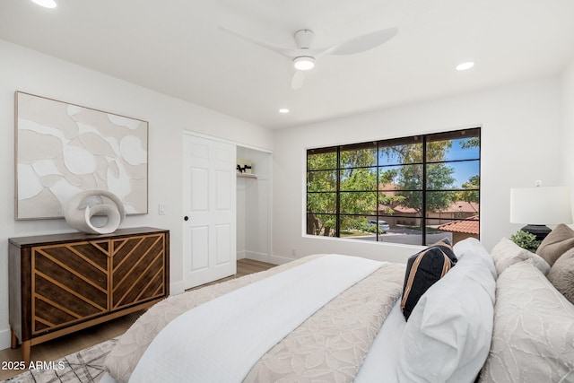 bedroom featuring baseboards, a ceiling fan, recessed lighting, and wood finished floors