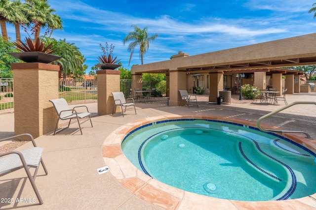 view of swimming pool with a patio and fence