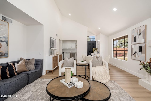 living room with light wood-style flooring, recessed lighting, baseboards, lofted ceiling, and visible vents