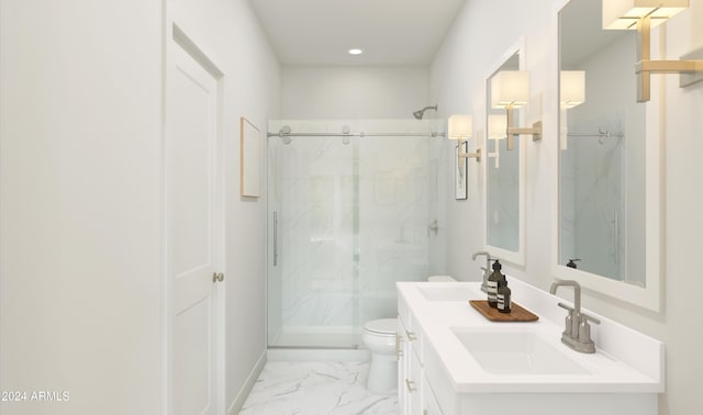 bathroom featuring vanity, toilet, and an enclosed shower