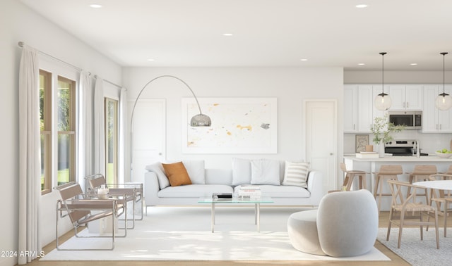 living room featuring sink and light wood-type flooring