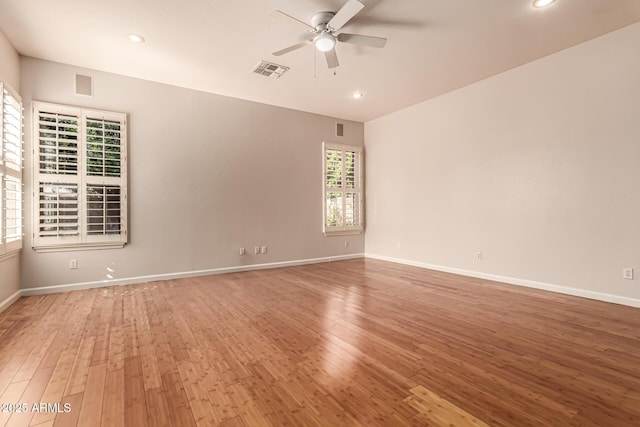 unfurnished room featuring ceiling fan, wood-type flooring, recessed lighting, baseboards, and visible vents