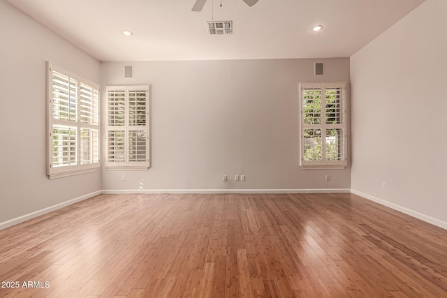 empty room with light wood-style flooring, a ceiling fan, baseboards, recessed lighting, and visible vents