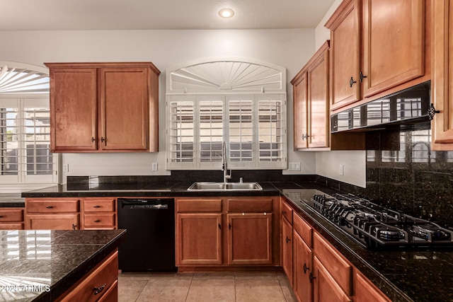 kitchen with brown cabinetry, a sink, light tile patterned floors, black appliances, and recessed lighting