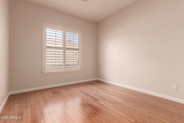 empty room with light wood-style floors and baseboards