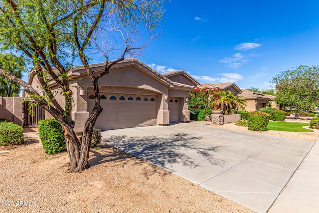 ranch-style home featuring a garage, fence, stucco siding, concrete driveway, and a tile roof